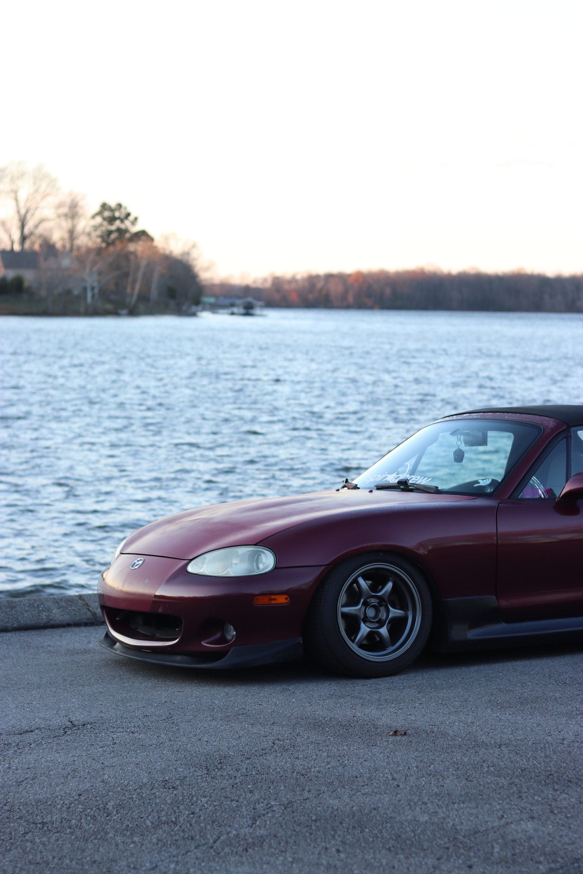 miata in front of lake