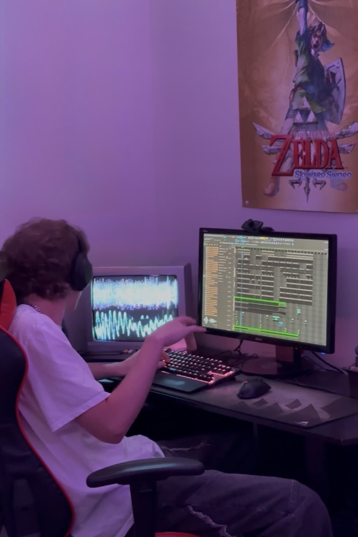 Producing music in FL Studio at a desk with headphones and two screens